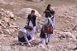 Girls looking at rocks.