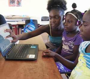 Young children using a laptop.