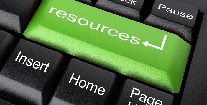A photo of a laptop computer with one key highlighted. The key reads, "Resources"