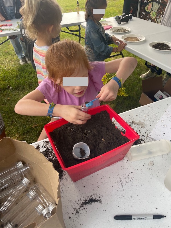 a student investigates soil at the Soil and Solar Festival