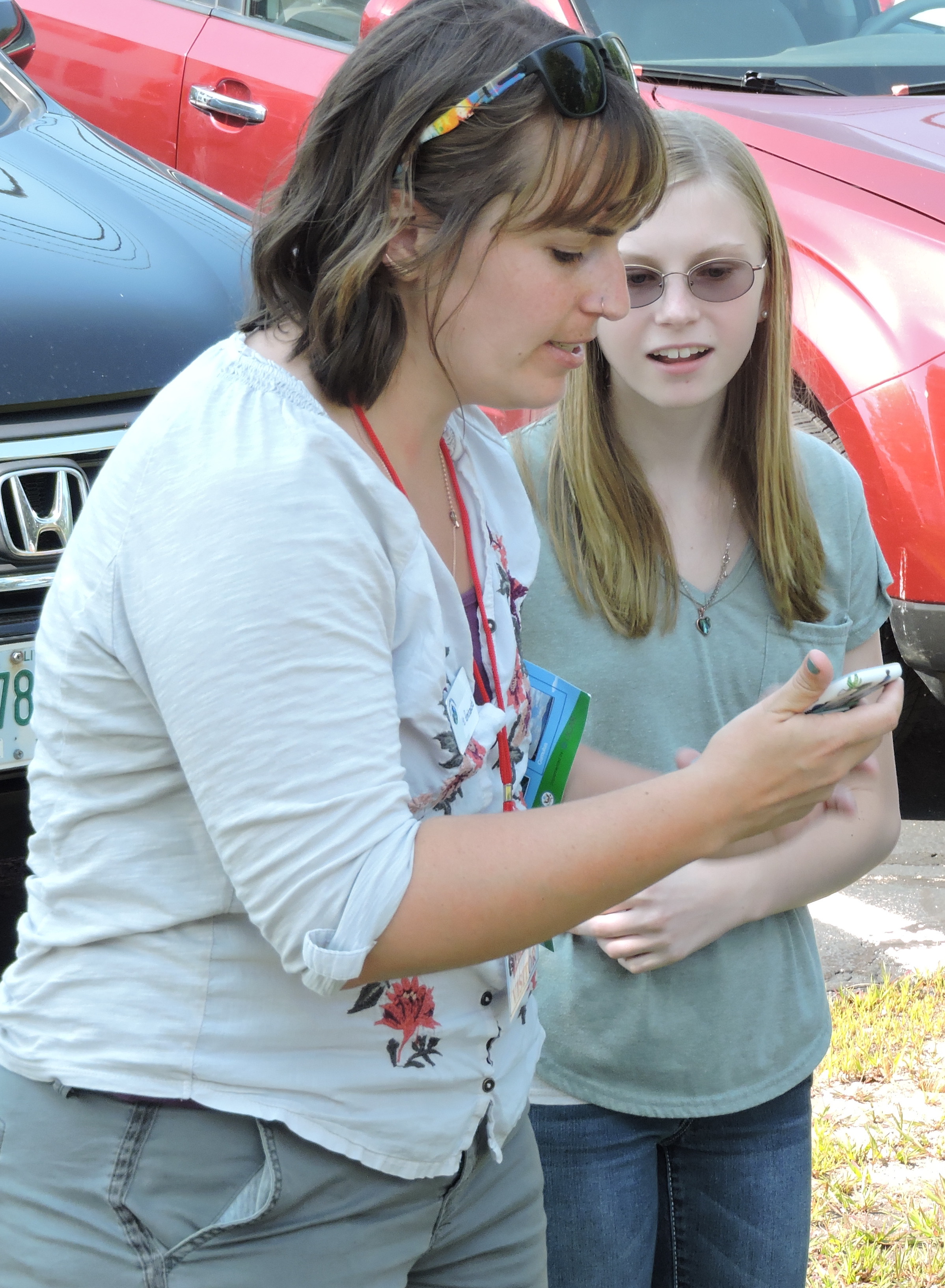 female graduate student with young female student looking with interest at the NASA observer app